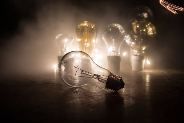 istock Abstract dark background with creative artwork decoration of glowing bulbs. 1205138989
