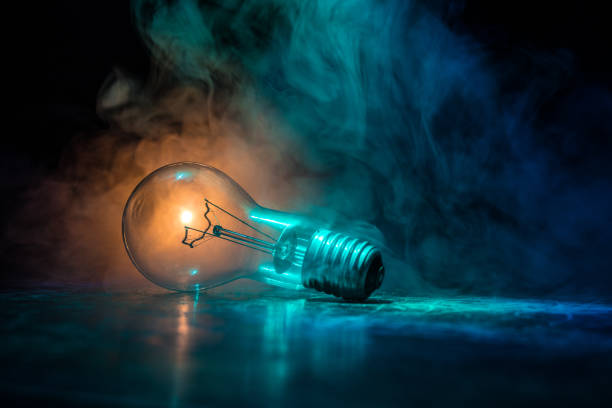 istock Abstract dark background with creative artwork decoration of glowing bulbs. 1205139018