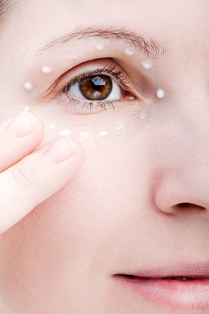 istock Women applying eye skin cream 120514235