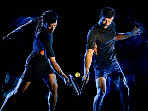 istock Tennis player man light painting isolated black background 1205143492
