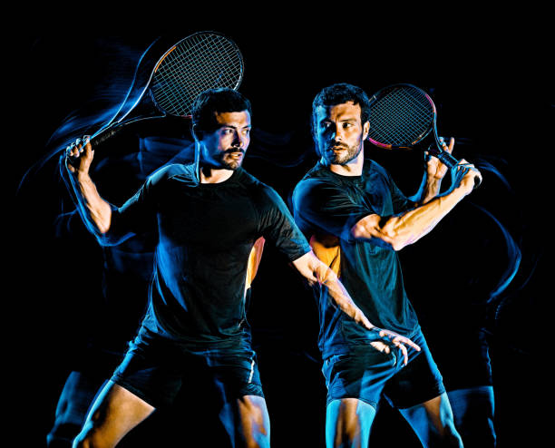 istock Tennis player man light painting isolated black background 1205143513