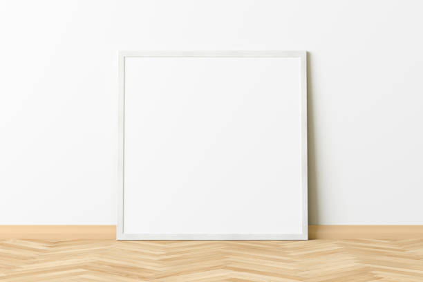 istock Blank poster frame mock up standing on the floor next to wall 1205144012