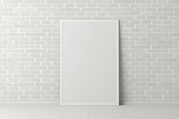 istock Blank poster frame mock up standing on the floor next to wall 1205144561