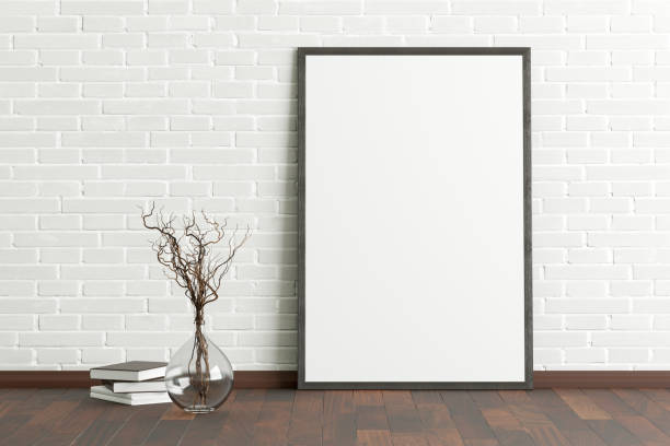 istock Blank poster frame mock up standing on the floor next to wall 1205144602