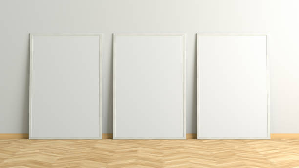 istock Blank poster frame mock up standing on the floor next to wall 1205144615