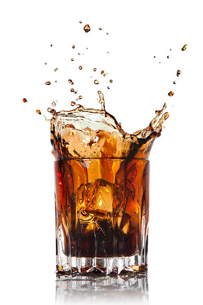 istock splash of cola in glass isolated on white 120514630