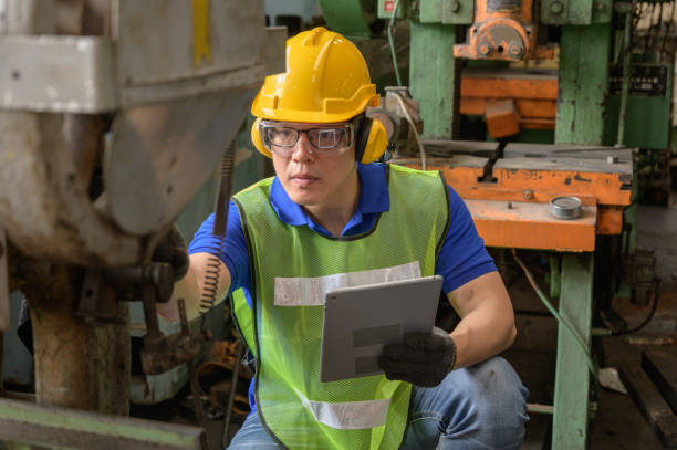 istock Male asian inspector, engineer working  in the production line process at industry 1205148081