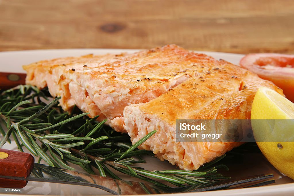 roast salmon on plate over wood  Backgrounds Stock Photo