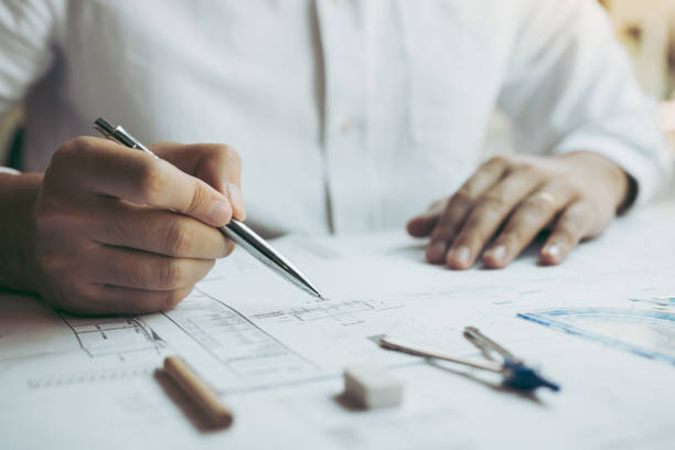 istock Engineers are designing working on blueprints and analyzing the structure of the project. 1205161016