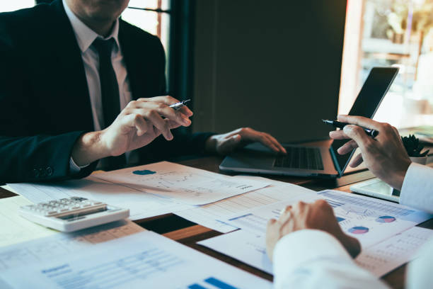 istock Business people pointing on statistic number result and analysis finance cost with checking summary reports graph in office. 1205161174