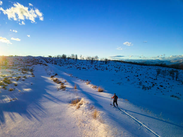 istock Man Skiing on Ski Tour in Mountains at Sunset 1205163696