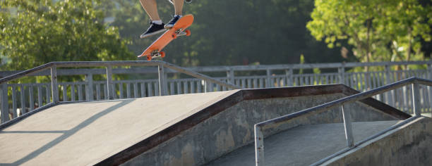 istock Skateboarder skateboarding at skatepark ramp 1205165693