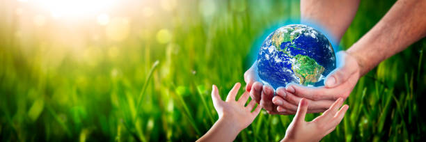 istock Hands Of Man Giving Earth To Child 1205166544