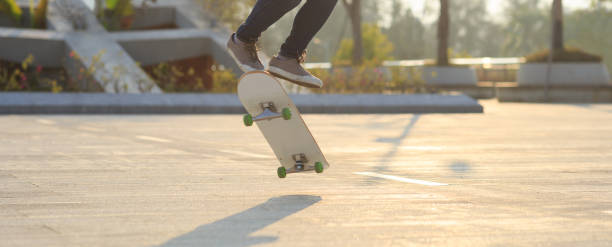 istock Skateboarder skateboarding at sunrise park 1205166652