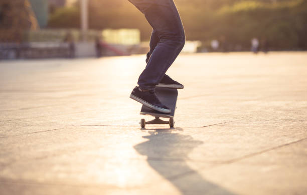 istock Skateboarder skateboarding at sunset city 1205167093