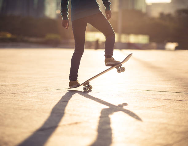 istock Skateboarder skateboarding at sunset city 1205167104