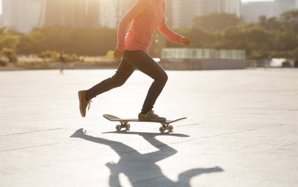 istock Skateboarder skateboarding at sunset city 1205167153