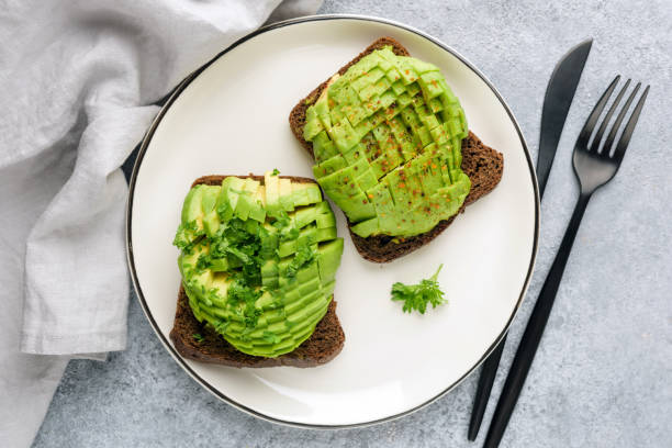 istock Rye bread toast with avocado and cilantro 1205169512