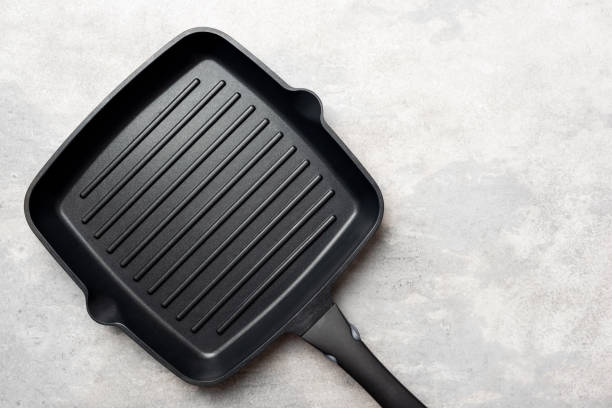 istock Cast Iron Grill Pan On Grey Concrete Background 1205169528