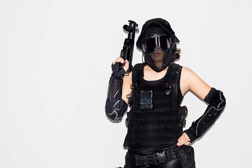 asian lady in black soldier bb gun sport game costume and weapon on white background