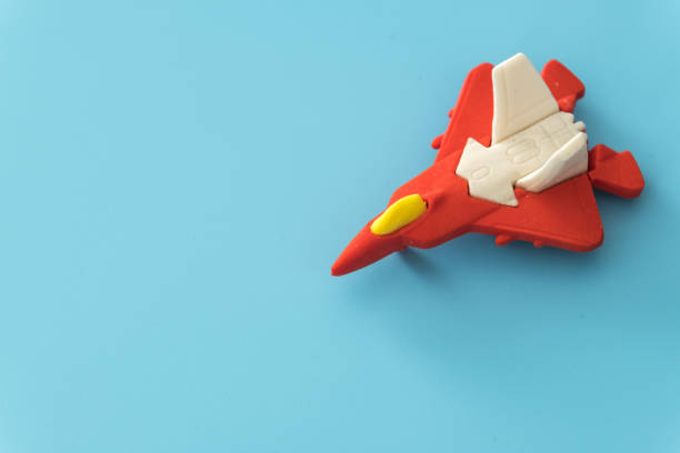 istock rubber fighter plane toy display on blue background view 1205171011