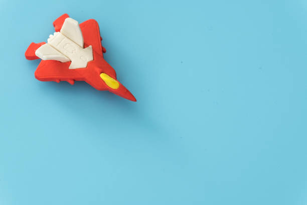 istock rubber fighter plane toy display on blue background view 1205171012