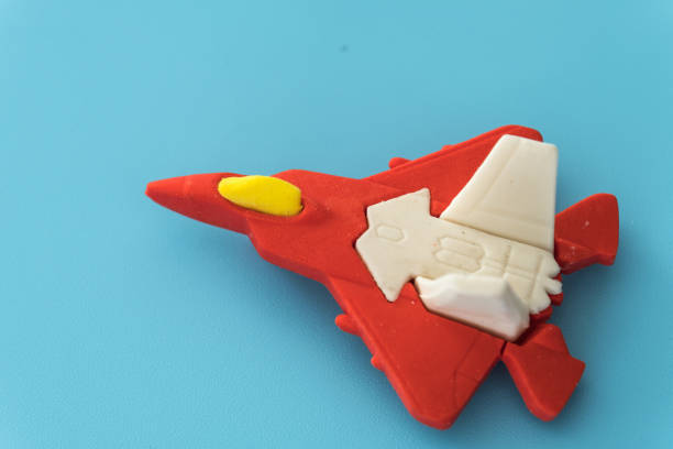 istock rubber fighter plane toy display on blue background view 1205171017