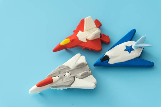 istock rubber fighter plane toy display on blue background view 1205171019