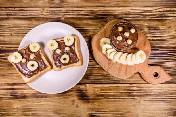 istock Two sandwiches with chocolate spread on a plate. Sandwich like a bear muzzle. Top view 1205173629