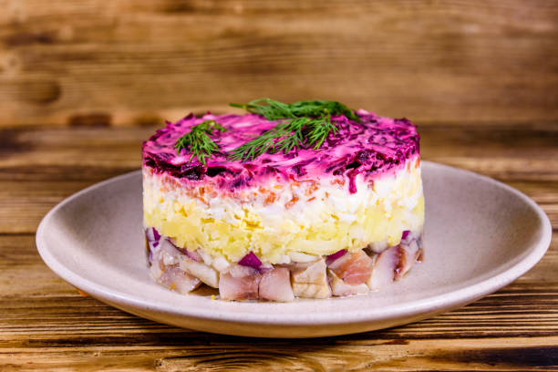 istock Ceramic plate with russian traditional new year salad herring under fur coat (shuba) and on rustic wooden table 1205173823