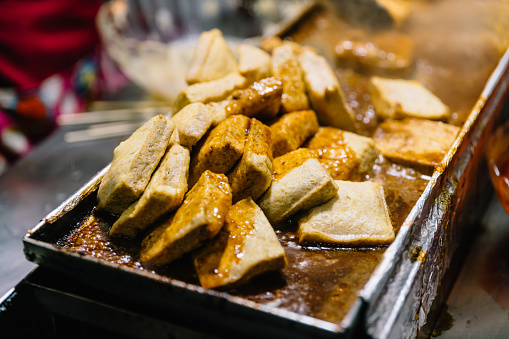 Close-up Fermented Tofu or Stinky Tofu on a hot plate, famous street food at Jiufen, Taiwan.