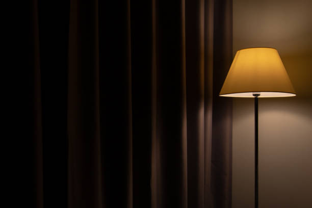 istock floor lamp stands near curtains 1205179685