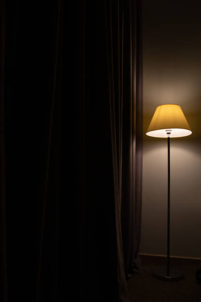 istock floor lamp stands near curtains 1205179699