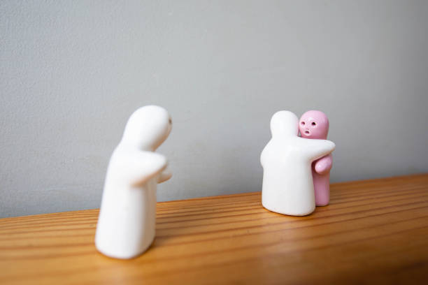 istock White and Pink ceramic hugging couple on grey walls background. An another ceramic see it and feeling sad. 1205179936
