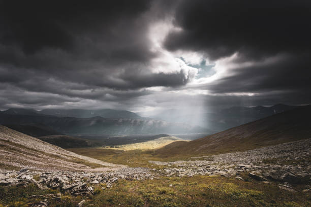 istock Mountain landscape. A ray of the sun breaks through the clouds 1205180239