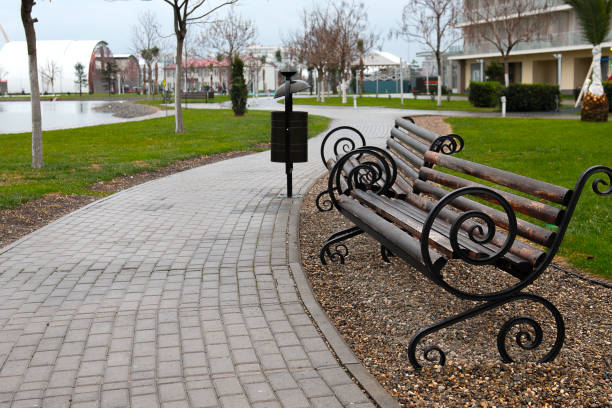 istock bench for relaxation near the footpath 1205185674