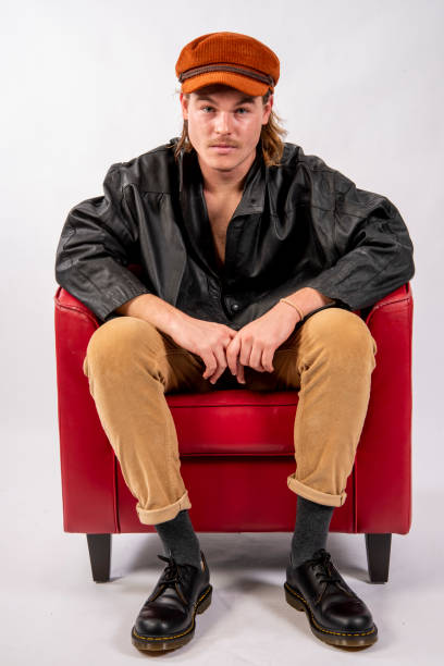 istock Attractive young man lounging in a Red Chair. 1205186168