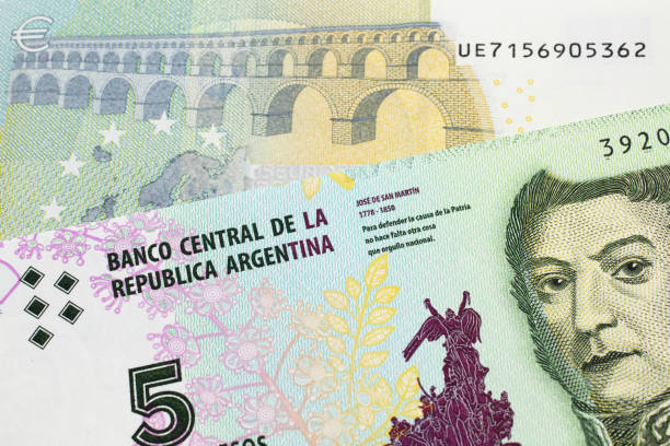 istock A peso note from Argentina, close up with a European, euro bill 1205189100