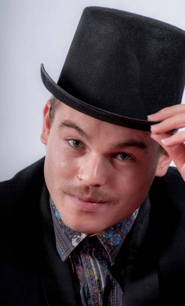 istock Attractive young man doffs his hat at the camera. 1205189144