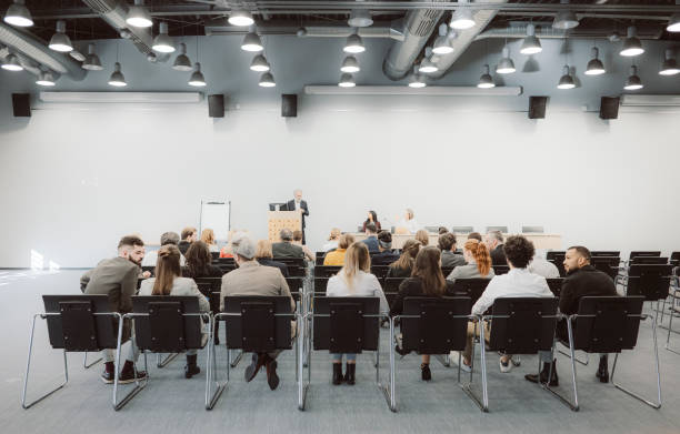 istock Business people sitting at seminar 1205189936