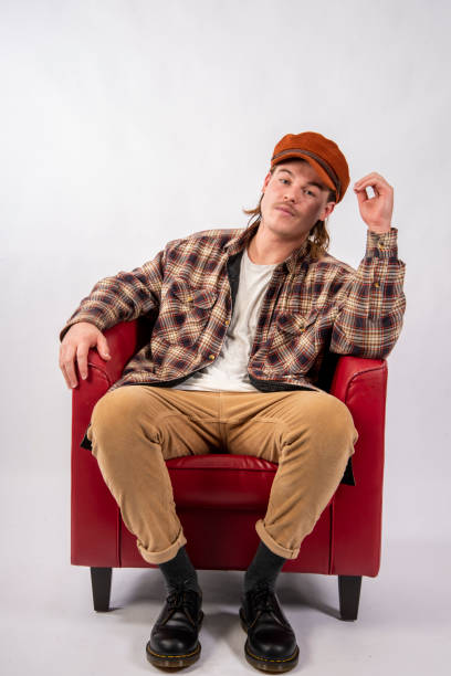 istock Attractive young man lounging in a Red Chair. 1205190699