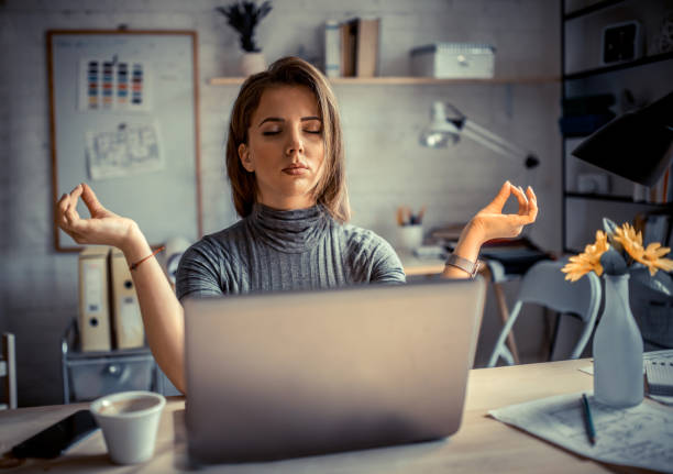 istock Woman in office meditating 1205192330