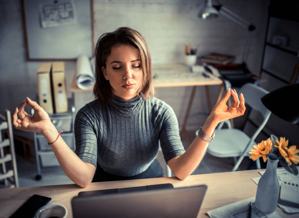 istock Woman in office meditating 1205192333