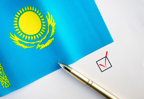 Pencil, Flag of Kazakhstan and check mark on paper sheet
