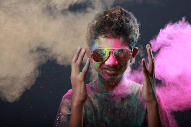 istock Young boy plays with Holi festival colours 1205195562
