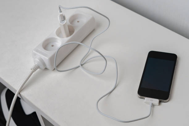 istock a socket with a phone wire quick charger on the white shelf 1205198723