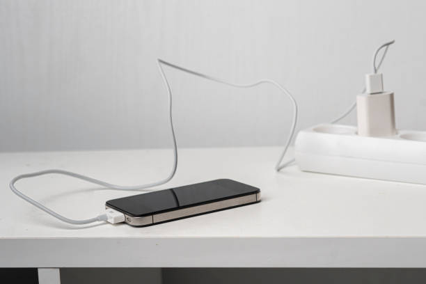 istock a socket with a phone wire quick charger on the white shelf 1205198725