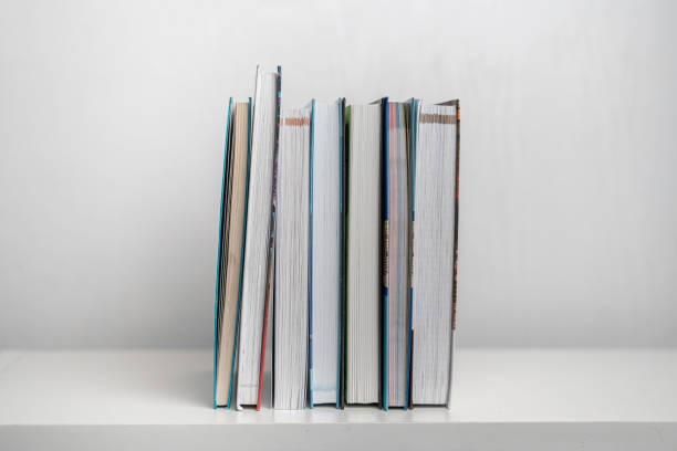 istock a simple stack of books on the shelf at home 1205198731