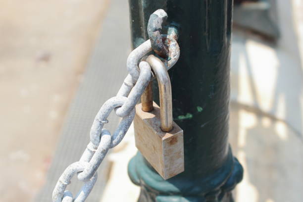 istock Padlock and chain on a fence 1205198956