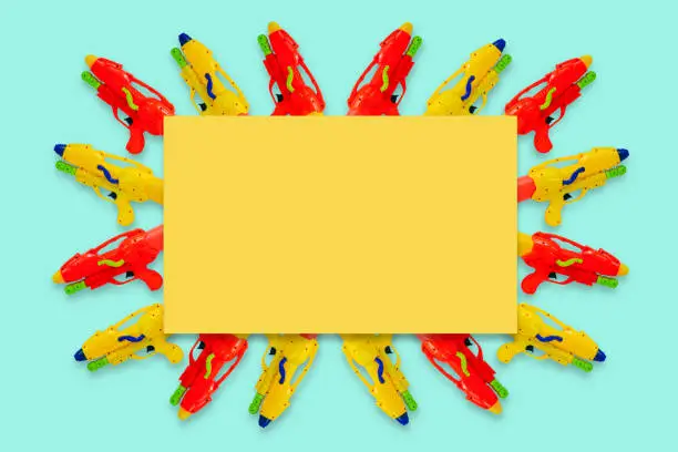 Photo of Colorful water guns with blank yellow space for text for Water or Songkran festival.